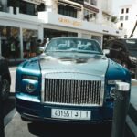 A rolls royce parked on the side of the road