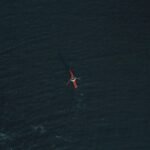 aerial photography of person riding on kayak during daytime