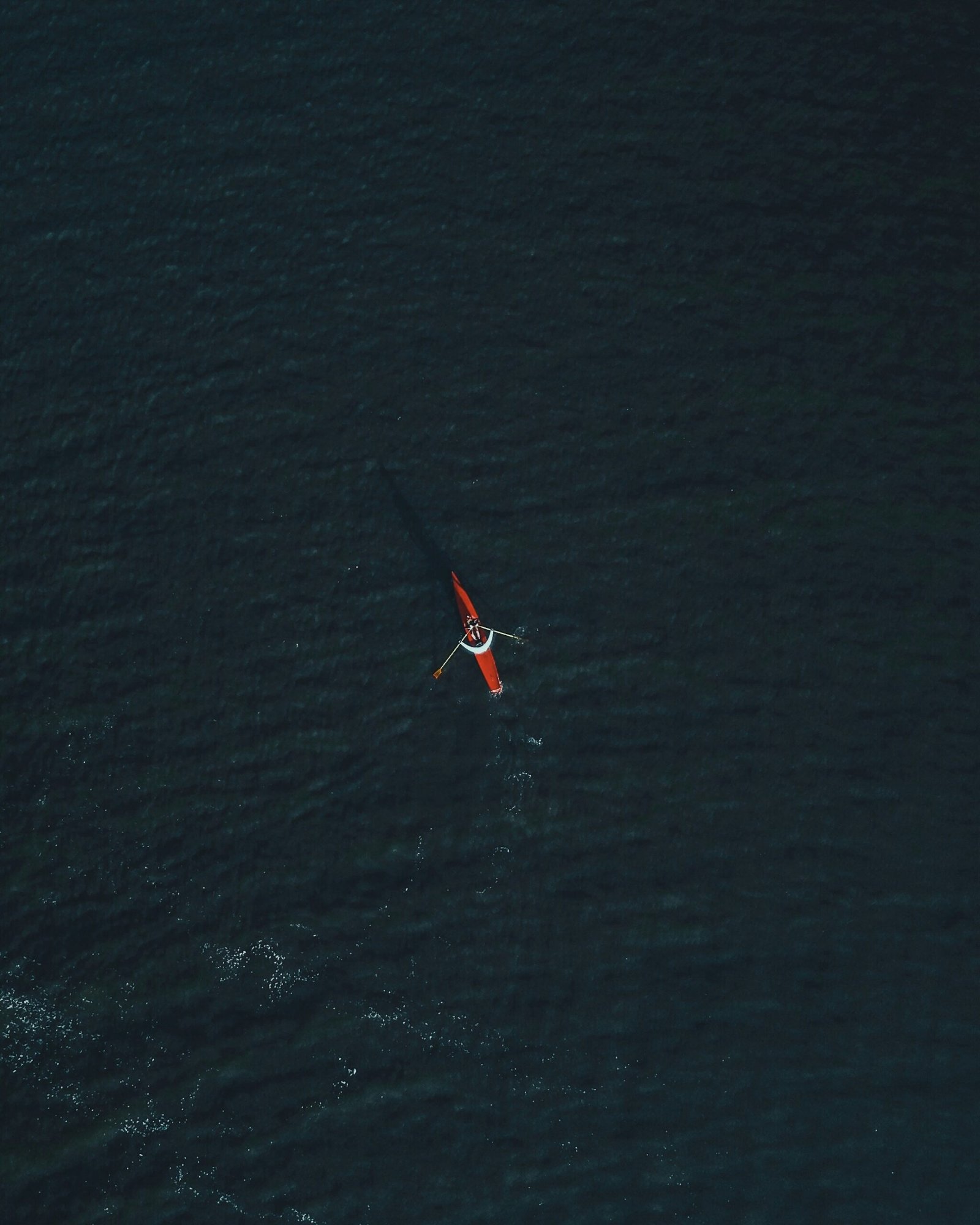 aerial photography of person riding on kayak during daytime